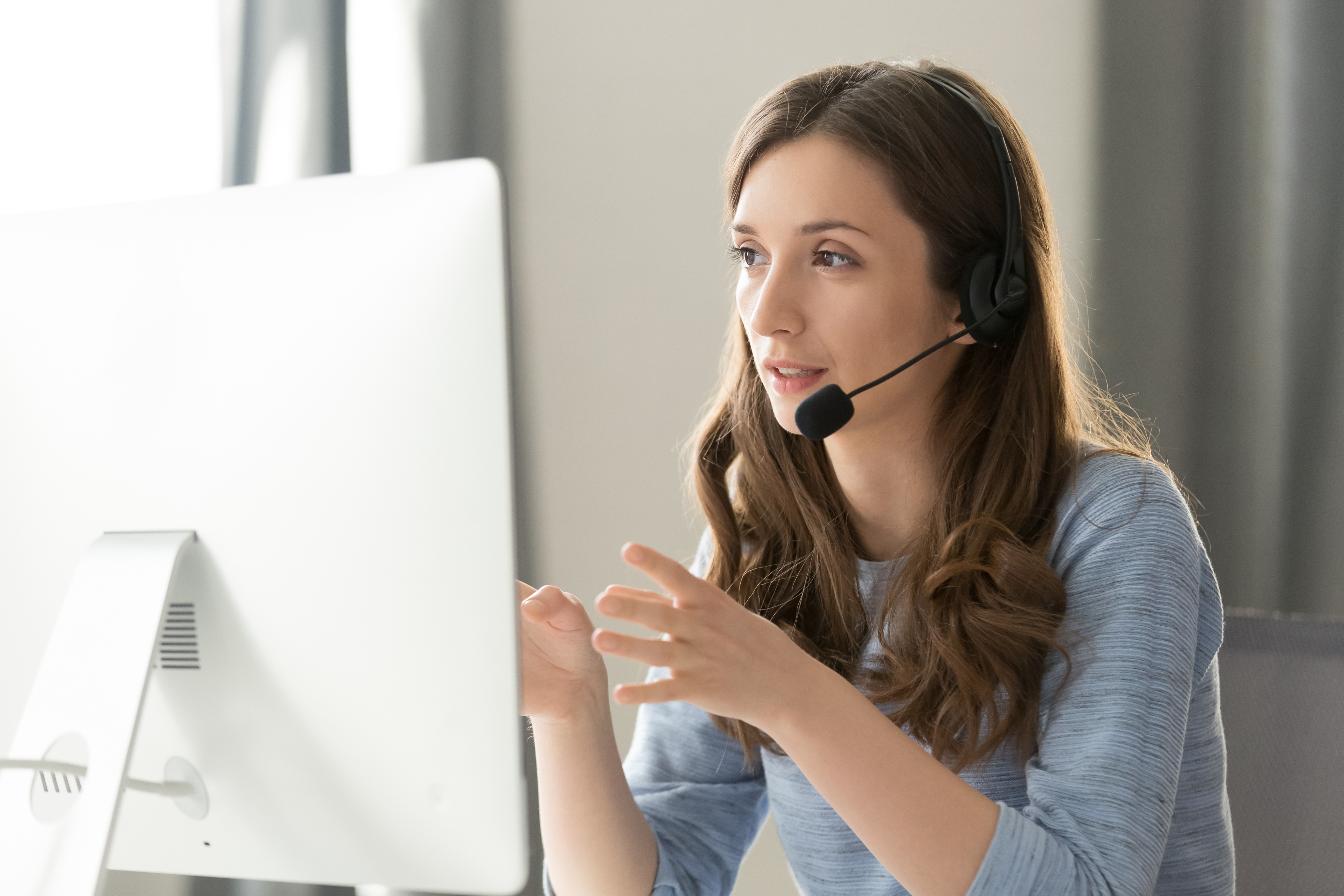 Woman at computer using headset