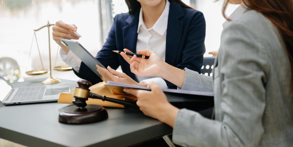 Two professional women in a legal discussion