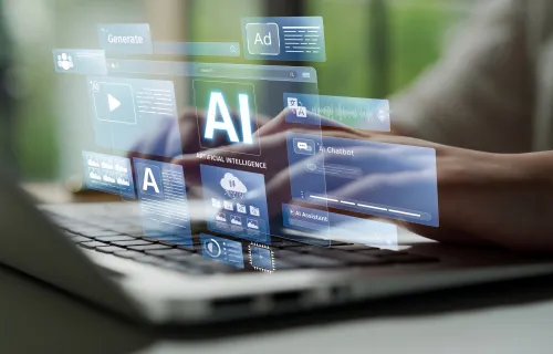 Person typing on computer with AI text on screen